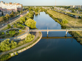 Bridge over the lake in the city park of Kiev. Aerial drone view.