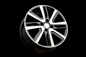 new alloy wheels on a black background. stylish and beautiful. auto parts and auto tuning