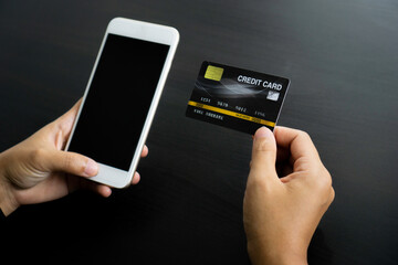 Businesswoman hand using mobile smart phone and creditcard, onlinepament, banking and online shopping at the home office.