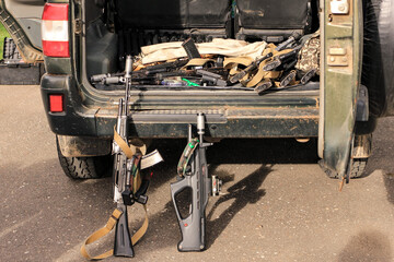 Lasertag or laser war tag equipment weapon in the trunk of the car. Guns, rifles and head band...