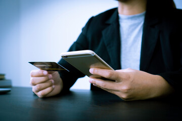 Business woman using a smartphone to fill out credit card information for online trading, online shopping ideas.