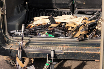 Lasertag or laser war tag equipment weapon in the trunk of the car. Guns, rifles and head band...