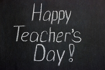Fototapeta premium Lettering on a chalkboard Happy Teacher's Day! Congratulatory inscription
