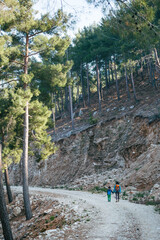 The boy with his mother go hiking.