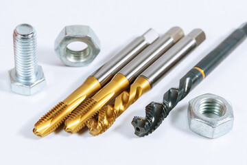 Set of tap for threading in metal. Bolts and nuts isolated on white background. Tool for metal...