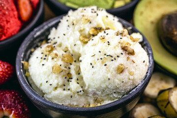 natural banana ice cream, without preservatives, with Brazilian tropical fruits in the background, gourmet ice cream