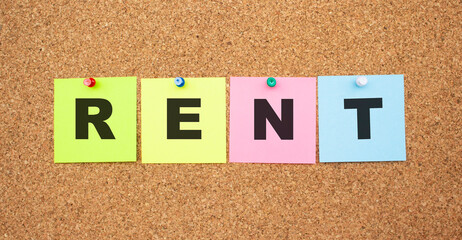 Multicolor notes with letters pinned on a cork notice board.