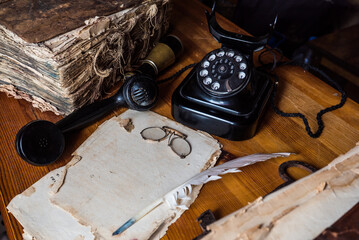 writing a letter from the past, vintage desk vintage off-hook rotary telephone and vintage accessories