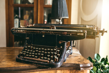 Close-up old-fashioned typewriter on a desk. Vintage, hipster decor concept.