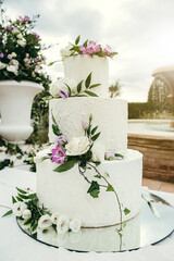 Close-up wedding cake with flowers decoration. Elegance, cake designer concept.