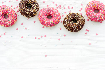 Donuts flat lay pattern on white background, top view
