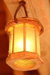 Vintage wooden lantern foreground outdoors on a sunny day. Street lighting in parks.