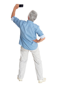 Senior Man Taking Selfie On White Background