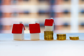 Home and money on the background of a building under construction.
