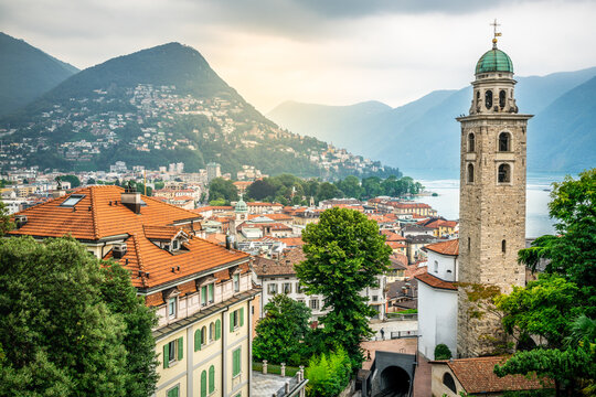 Scenic cityscape of Lugano with Cathedral of Saint Lawrence bell tower and lake view and dramatic light in Lugano Switzerland