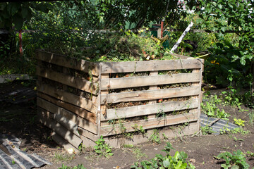 Fototapeta na wymiar Homemade box made of wooden boards for composting