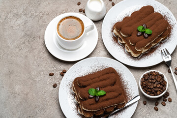 Classic tiramisu dessert, cup of coffee, sugar and milk on concrete background