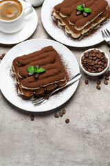 Classic tiramisu dessert, cup of coffee, sugar and milk on concrete background