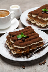 Classic tiramisu dessert, cup of coffee, sugar and milk on concrete background