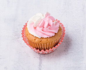 cream cupcake on white background, close-up