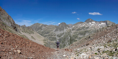Man hiking in mountains. Hiking in Pyrenees National Park, Hautes-Pyrenees, Occitanie in south of...