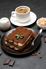 Classic tiramisu dessert, cup of coffee, sugar and milk on concrete background