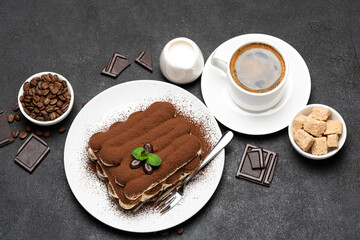 Classic tiramisu dessert, cup of coffee, sugar and milk on concrete background