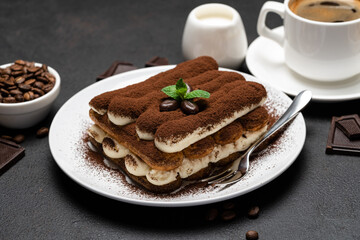 Classic tiramisu dessert, cup of coffee, sugar and milk on concrete background