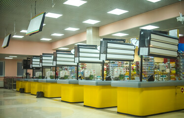 Supermarket yellow cashbox in the big shopping mall. Entrance of grocery store. retail company....