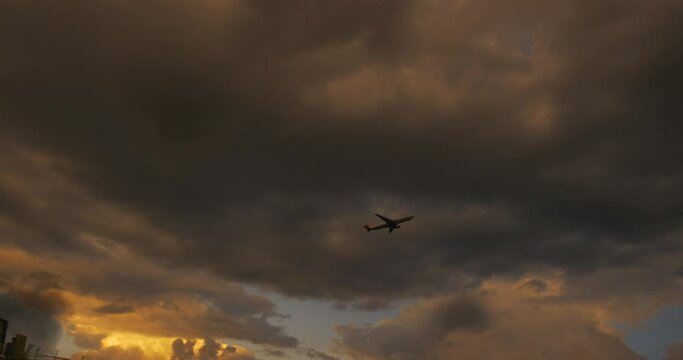 Passenger airliner takes off over a destroyed and burning city.

