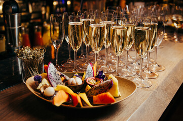 glasses of champagne on a table 
ecsotic fruits 