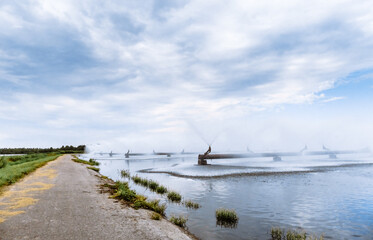 Combined heat and power plant and a lake with cooling fountains. CHP for the production and supply of the city's population with electricity and hot central water supply. Technology and nature