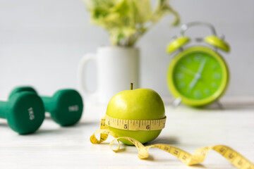 Close up green apple with measuring tape .  Diet Health Plan.  Nutrition start up workout planing....