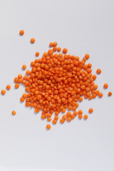 A bunch of red lentils isolated on a white background. View from above.