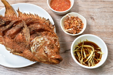 batter fried mango or red Tilapia fish with chop garlic dipping spicy and soy sauce