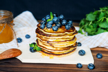 Pancakes with fresh blueberries and honey