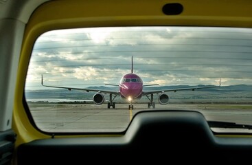  Front view of commercial passenger airliner, taxiing on airport apron after landing. View from the...