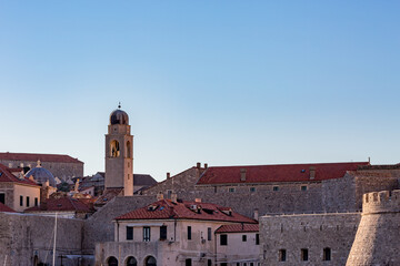 Detailed view with churches from outside, clear blue-sky sunny day. Scenery winter view of Mediterranean old city of Dubrovnik, famous European travel and historic destination, Croatia