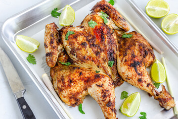 Thai Barbecued Whole Chickenon a Baking Tray with Cilantro, Lemon and Lemongrass Top Down Horizontal Photo