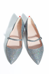 Elegant flat female shimmering shoes isolated on a white background.