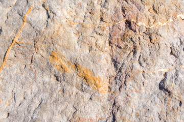 Closeup on rock rough natural mineral stone background, top view.