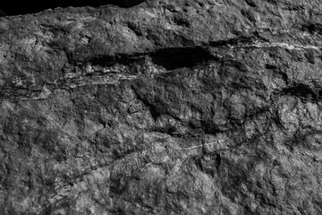 Closeup on rock rough natural mineral stone background, top view.