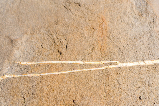 Closeup on rock rough natural mineral stone background, top view.