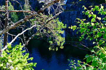 mountain lake with clear green water in granite and marble rocks in a natural monument