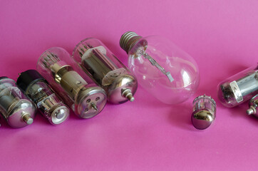 Various vacuum tubes on a pink background