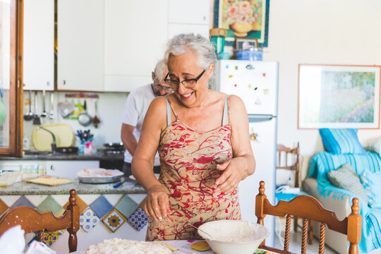 Middle Age Woman Indoors Preparing Food - Mature Retired Female At Home Cooking