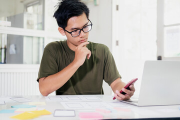 Web designer, UX UI designer designing mobile application user interface.