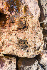 Closeup on rock rough natural mineral stone background, top view.