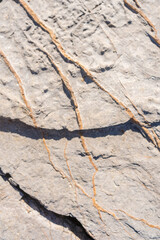 Closeup on rock rough natural mineral stone background, top view.