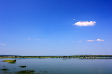 Calm blue surface of a lake under a blue sky
